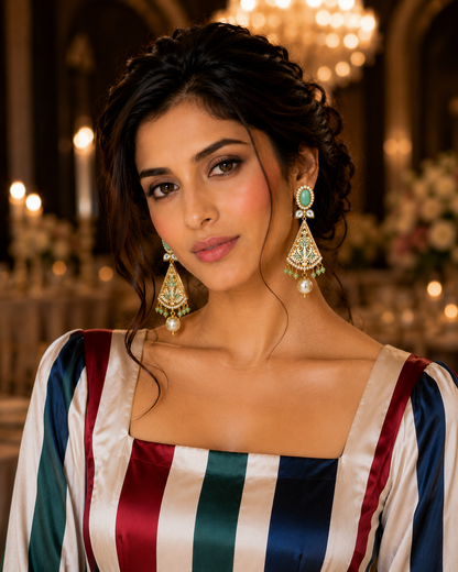 Model wearing Noorjahan Turquoise Meenakari Pearl Drop Earrings at candlelit gala - front view