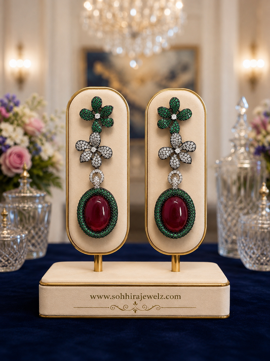 Emerald Garden Ruby Drop Earrings on luxury cream display stand