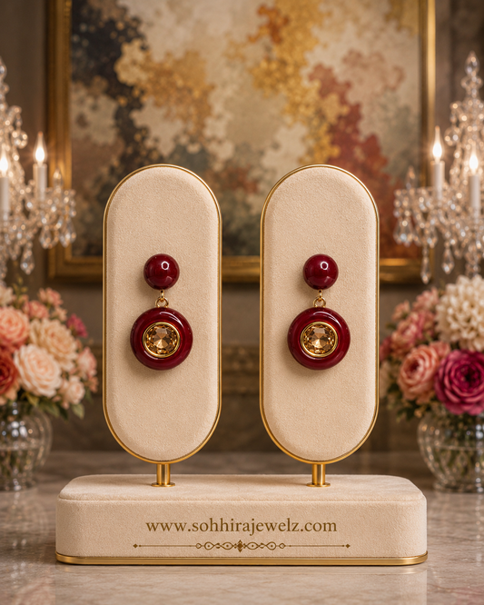Crimson Enamel Citrine Drop Earrings on luxury cream oval display stands with candelabras and roses