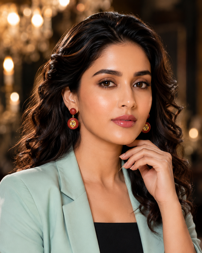 Model wearing Crimson Enamel Citrine Drop Earrings with mint blazer - front view chandelier backdrop